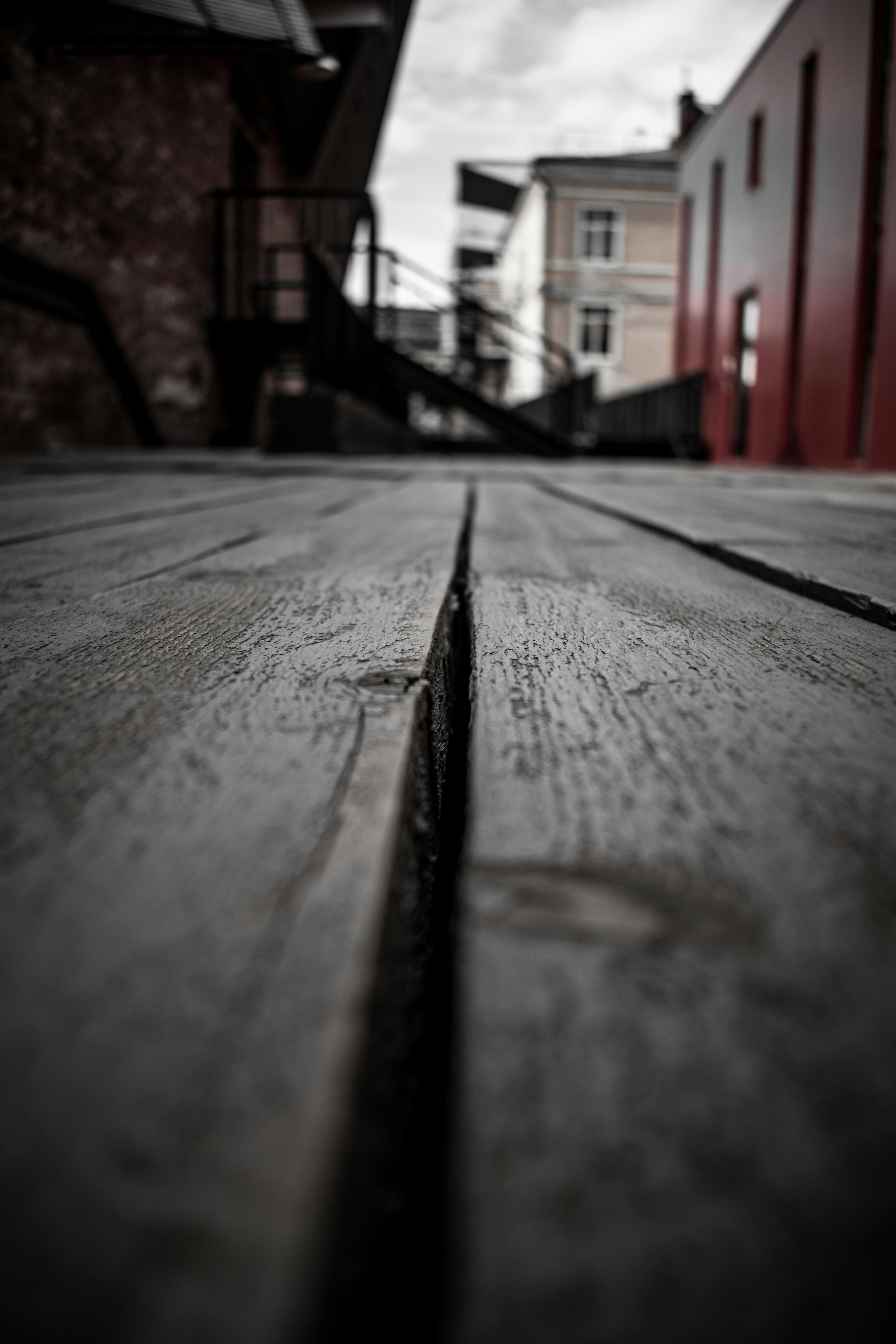 brown wooden plank in front of red building